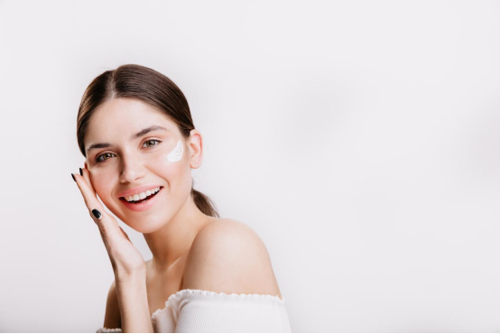 A beautiful woman is applying skin care products A beautiful woman is applying skin care products